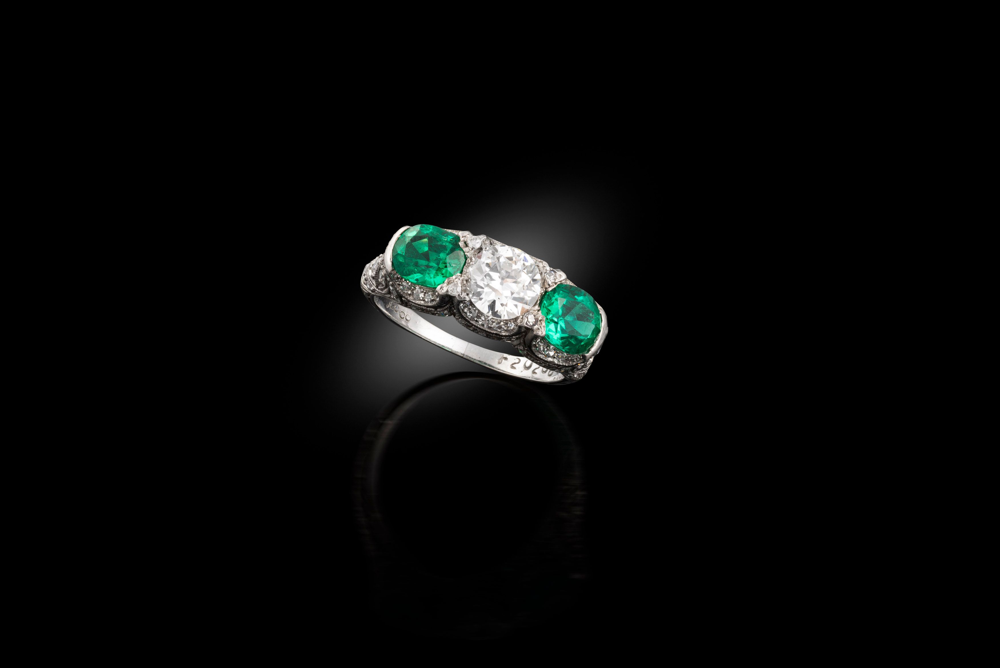 An emerald and diamond 3 stone ring