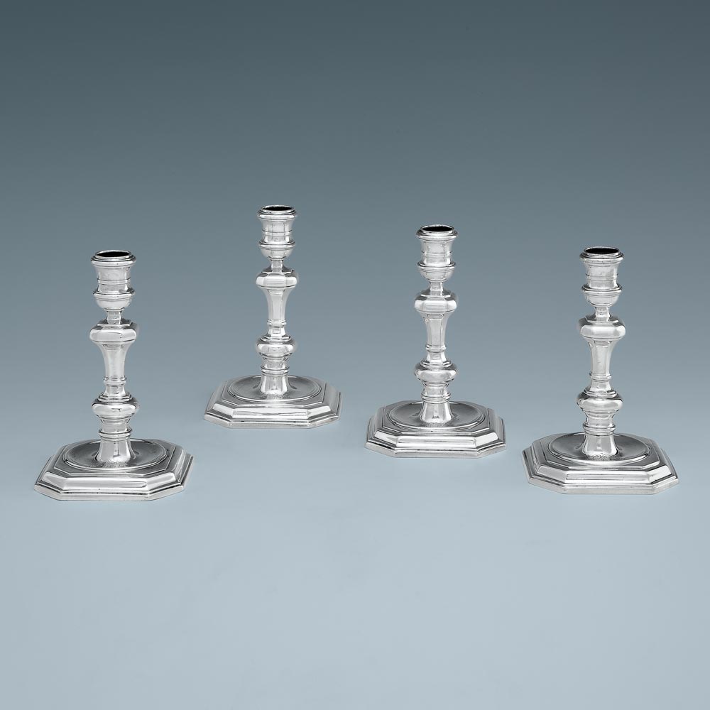 A Set of Four Queen Anne Antique English Silver Candlesticks