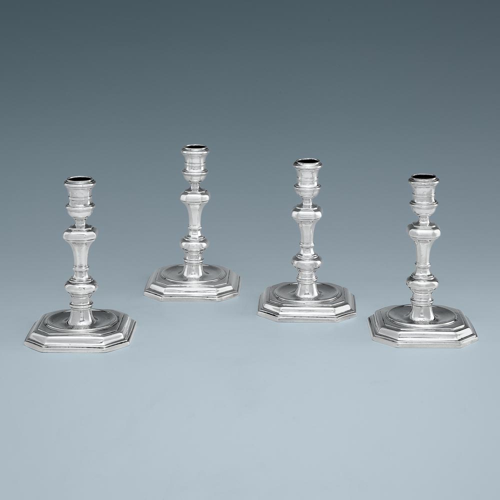 A Set of Four Queen Anne Antique English Silver Candlesticks