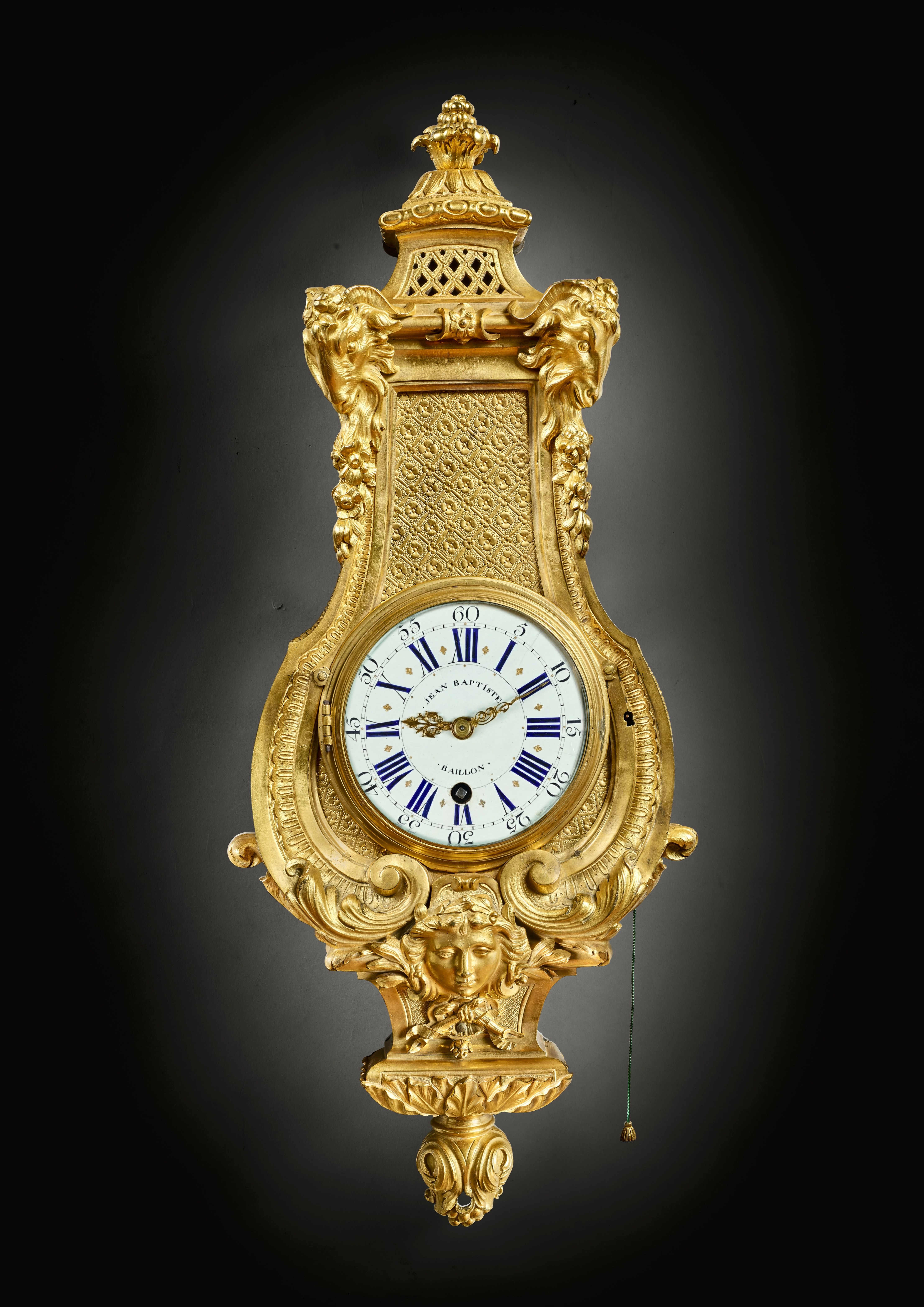 Lyre-shaped cartel clock adorned with a mask and ram's heads