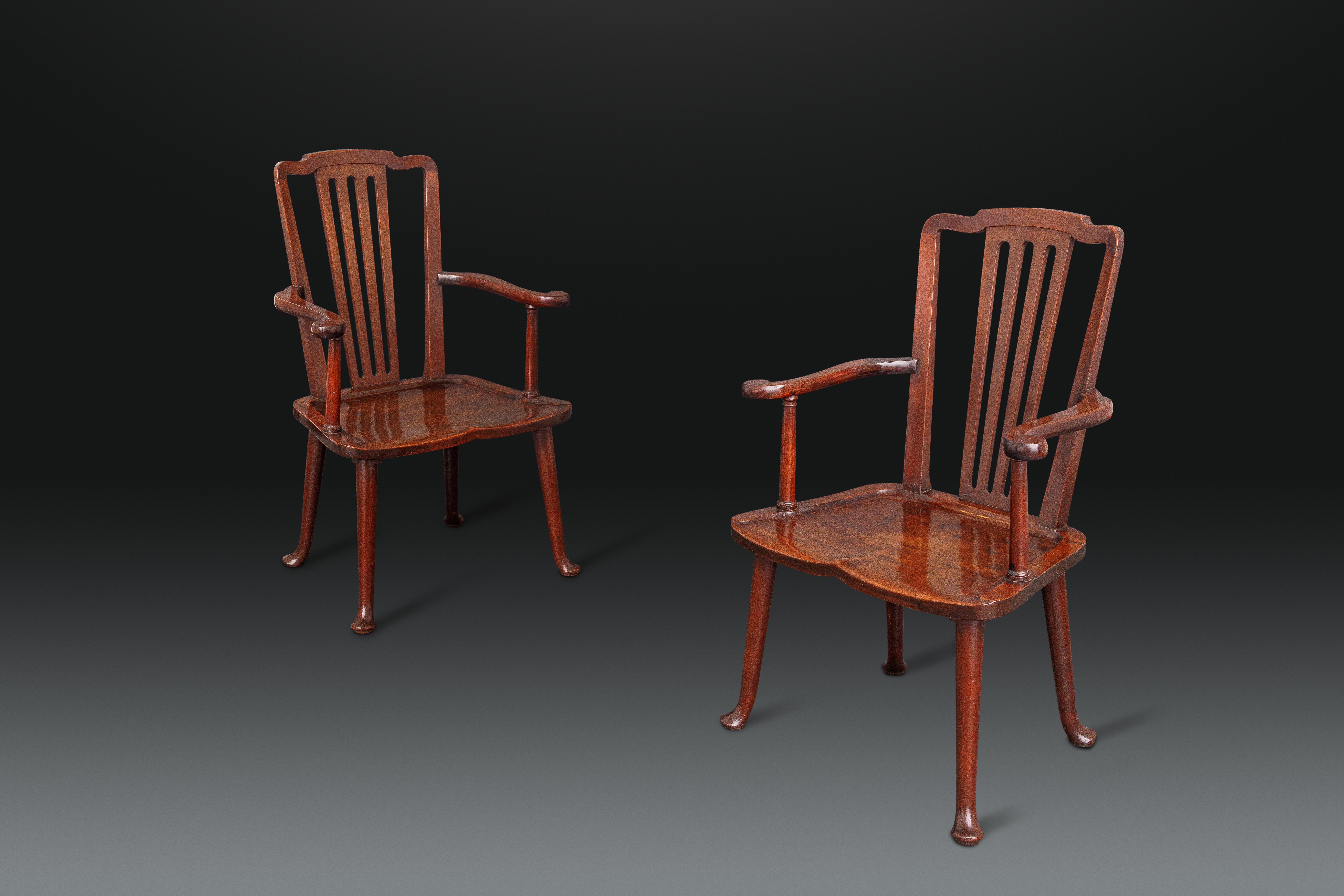 A Highly Unusual Pair of George II Mahogany Hall Armchairs with Dished Seats