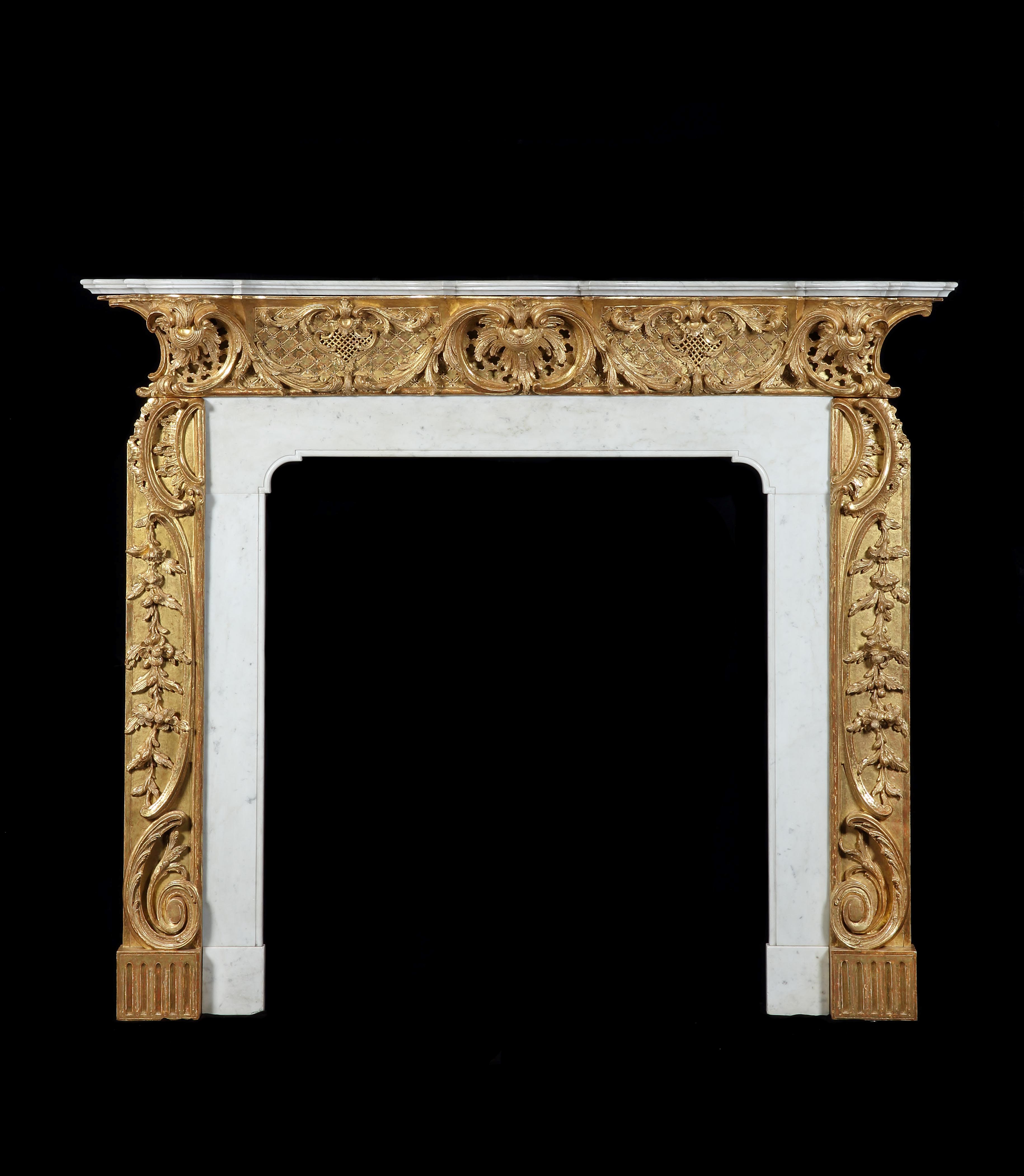 A GEORGE II GILTWOOD AND STATUARY MARBLE CHIMNEYPIECE TO A DESIGN BY THOMAS JOHNSON