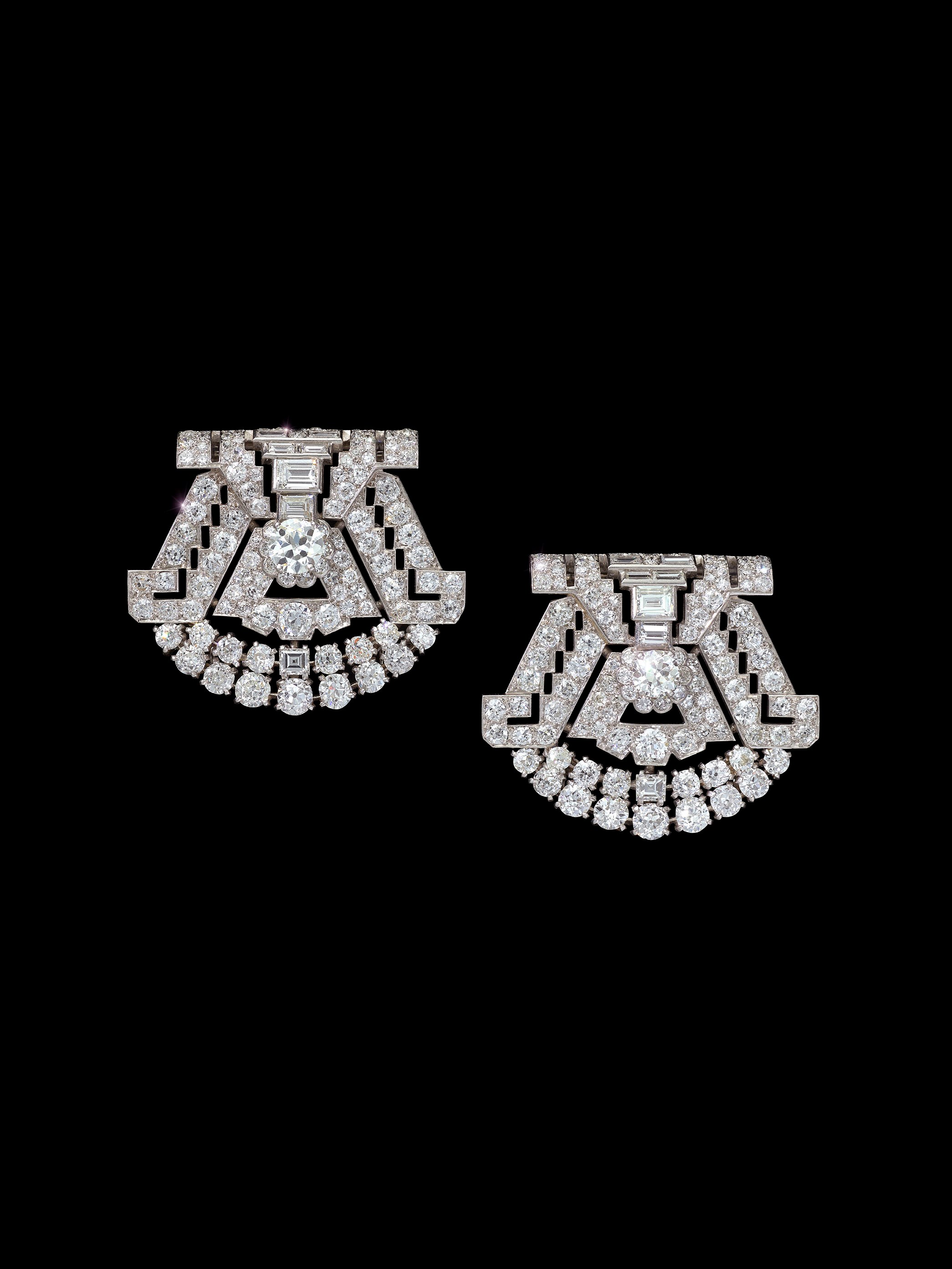 A pair of diamond set clips and brooch by Cartier